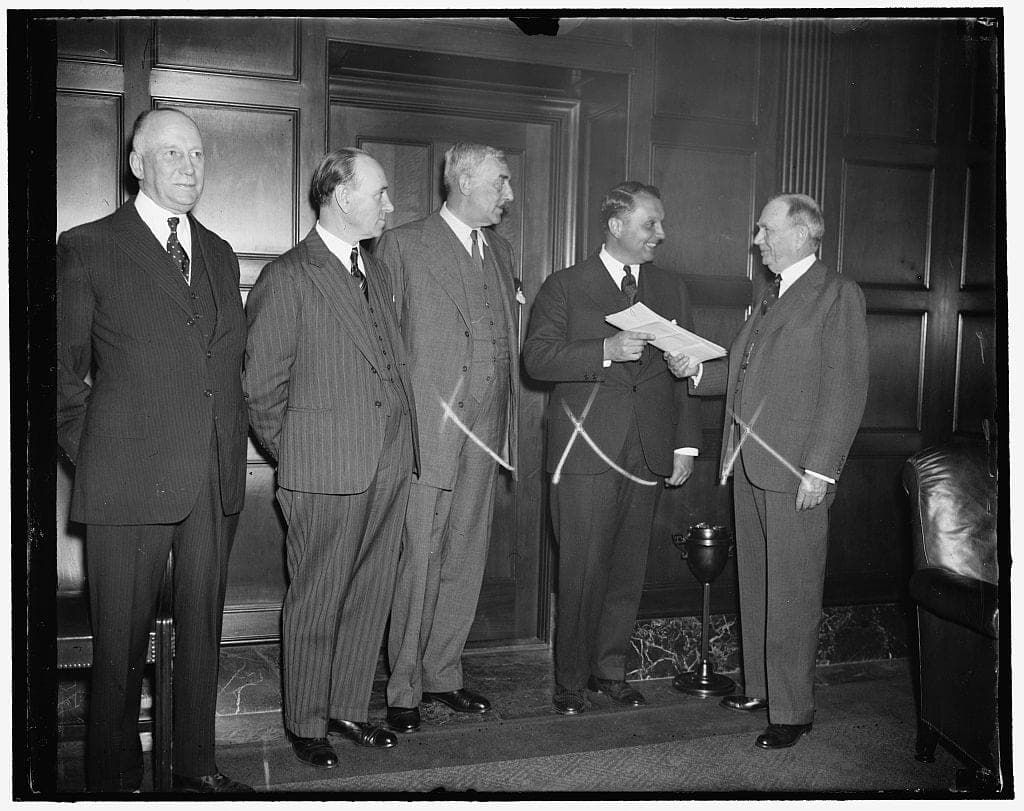 Juan T. Trippe, president of Pan American Airways, receiving trans-Atlantic flight permits, Washington D.C., April 1937